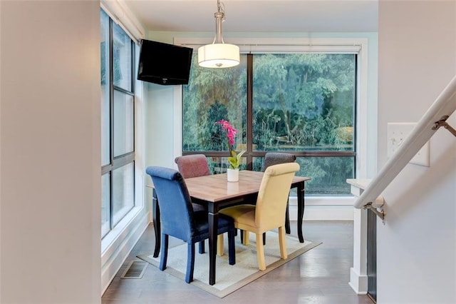 dining space featuring wood-type flooring