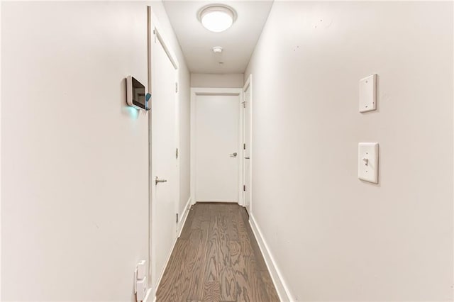 hallway with wood-type flooring