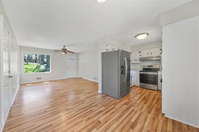 kitchen featuring light wood finished floors, ceiling fan, white cabinets, under cabinet range hood, and appliances with stainless steel finishes