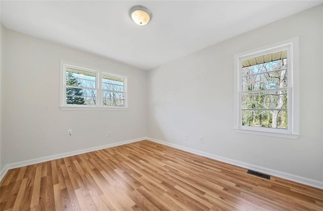 spare room featuring visible vents, baseboards, and a healthy amount of sunlight