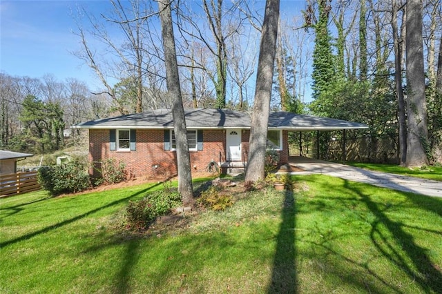 view of front of property with an attached carport, fence, concrete driveway, a front lawn, and brick siding