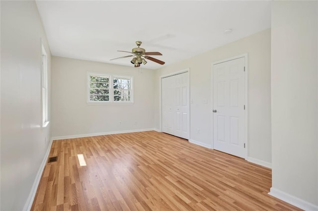 unfurnished bedroom with visible vents, baseboards, light wood-type flooring, and ceiling fan