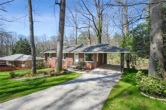 ranch-style home with concrete driveway, a carport, brick siding, and a front yard