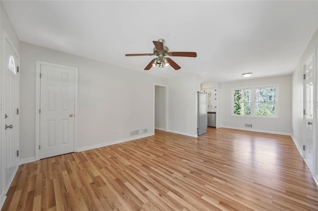 unfurnished living room featuring light wood-type flooring, visible vents, baseboards, and ceiling fan