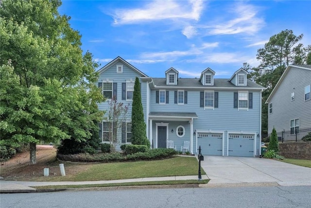 colonial inspired home with a front yard and a garage