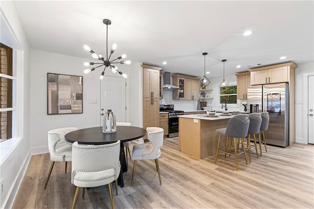 dining area featuring a notable chandelier, recessed lighting, light wood-type flooring, and baseboards