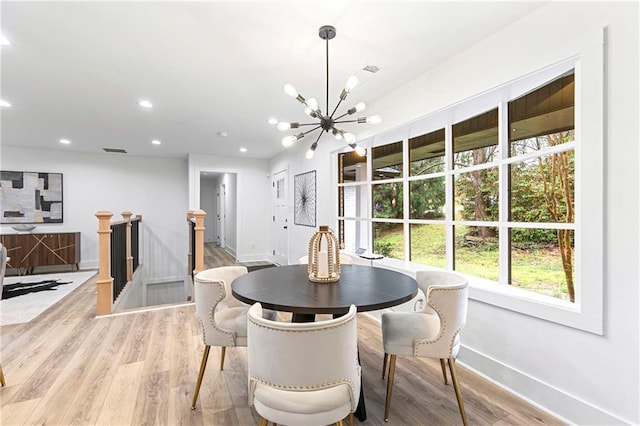 dining space with visible vents, baseboards, recessed lighting, light wood-style floors, and a notable chandelier