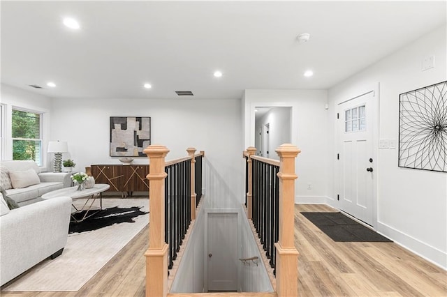 living area with recessed lighting, light wood-type flooring, baseboards, and visible vents