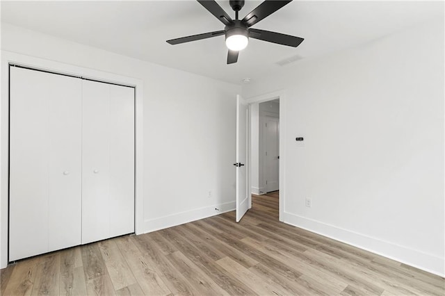 unfurnished bedroom with visible vents, baseboards, ceiling fan, light wood-style flooring, and a closet