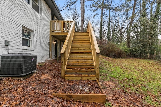 exterior space featuring stairway, central AC, and a wooden deck