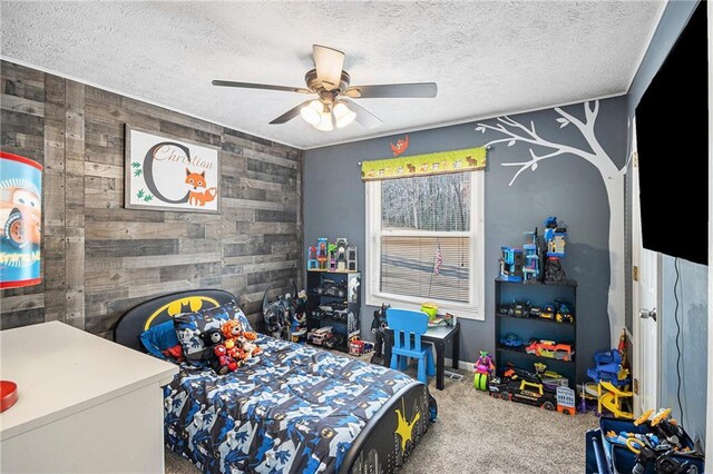 6355 Queens Rd, Douglasville, GA 30135 - bedroom with an accent wall, ceiling fan, carpet floors, and a textured ceiling