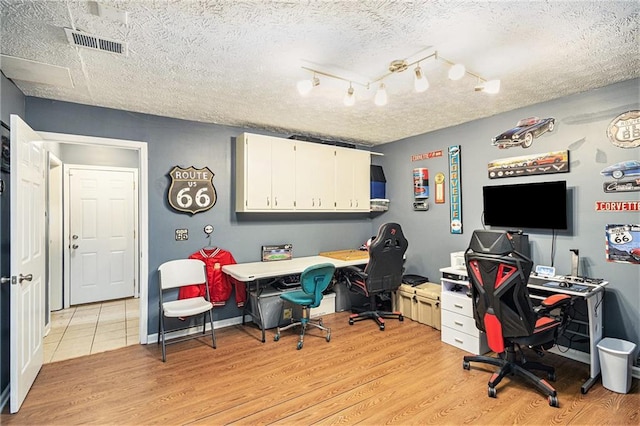 6355 Queens Rd, Douglasville, GA 30135 - office space with light wood finished floors, visible vents, a textured ceiling, and baseboards