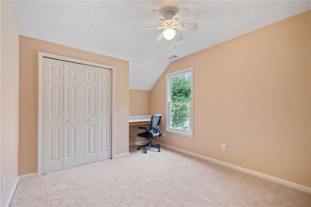 unfurnished office featuring carpet flooring, ceiling fan, lofted ceiling, and baseboards