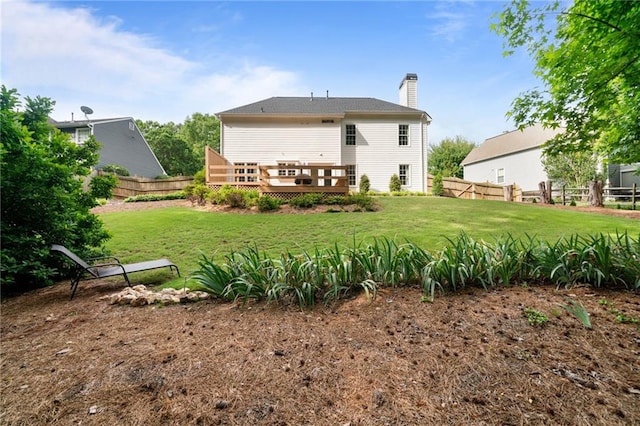 back of house featuring a chimney and a deck