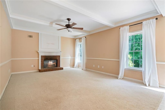 unfurnished living room with crown molding, a ceiling fan, a fireplace, carpet floors, and baseboards