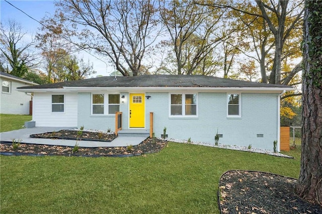 ranch-style house with a front yard, crawl space, and brick siding