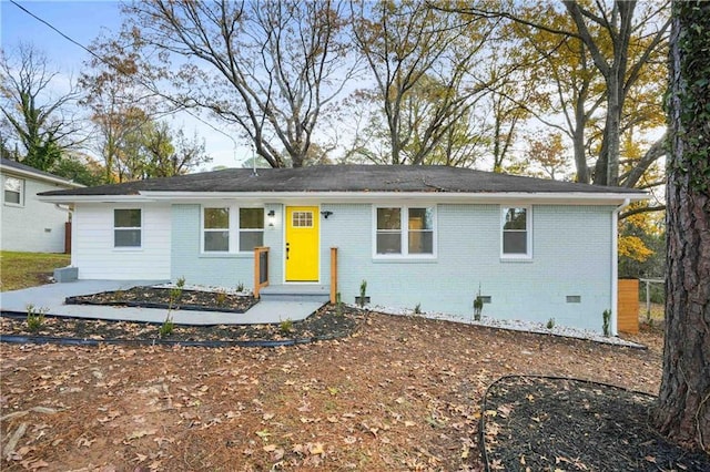 ranch-style house featuring brick siding and crawl space