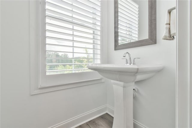 bathroom with wood finished floors and baseboards