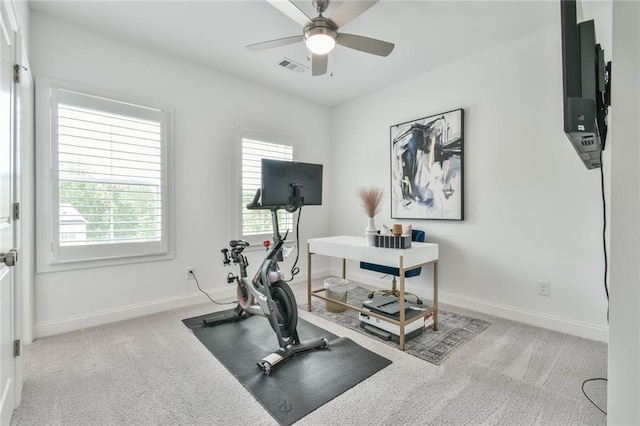 exercise room featuring plenty of natural light, visible vents, baseboards, and ceiling fan