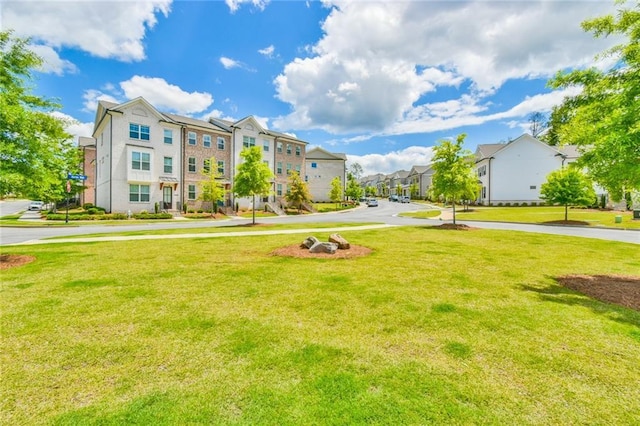 view of property's community with a residential view and a lawn