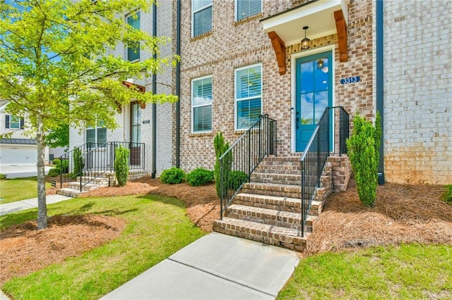 entrance to property featuring brick siding