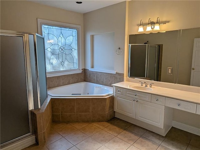 full bathroom featuring a garden tub, a shower stall, vanity, and tile patterned floors