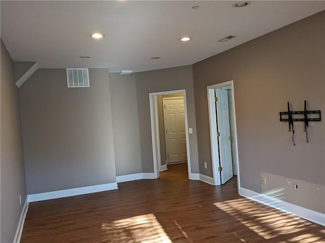 spare room featuring recessed lighting, visible vents, baseboards, and wood finished floors