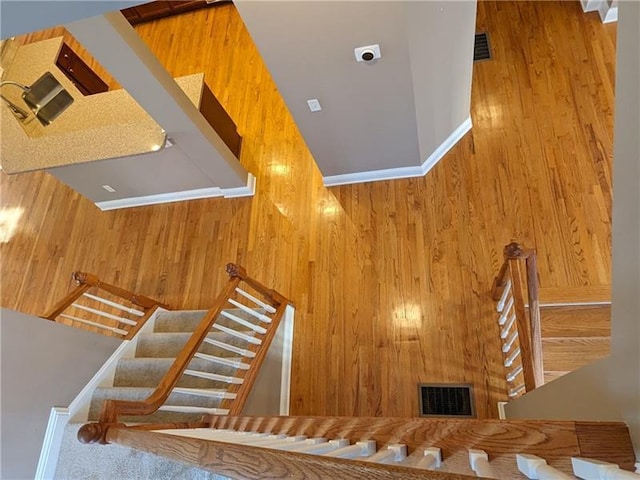 stairway featuring a fireplace and visible vents