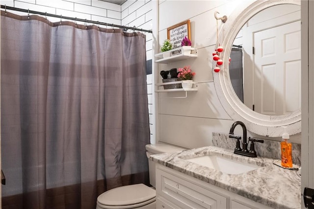 full bathroom featuring vanity, shower / bath combination with curtain, and toilet