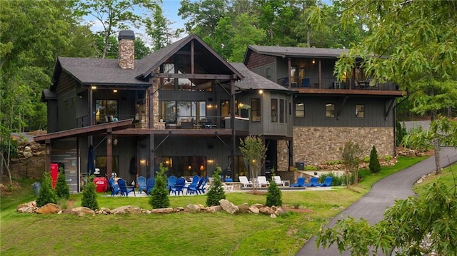 back of house with a lawn and a patio area