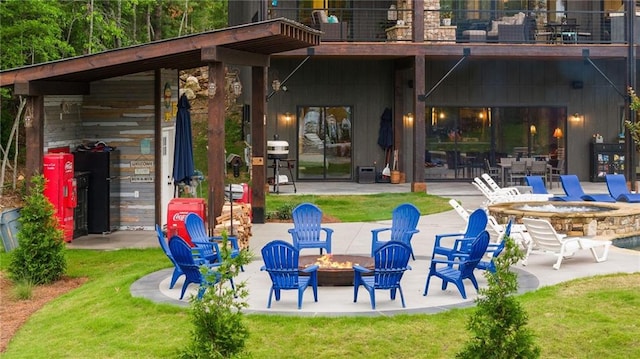 back of house with a fire pit, a patio area, and a yard