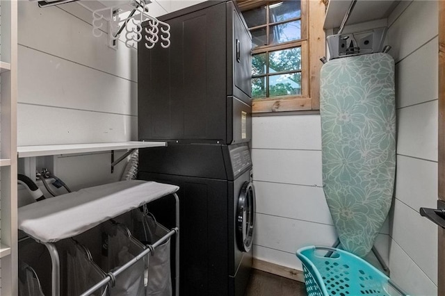 laundry area featuring stacked washer / dryer