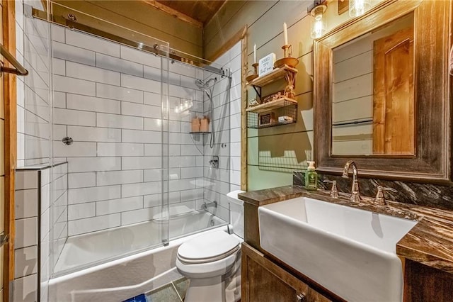 full bathroom with vanity, toilet, and bath / shower combo with glass door