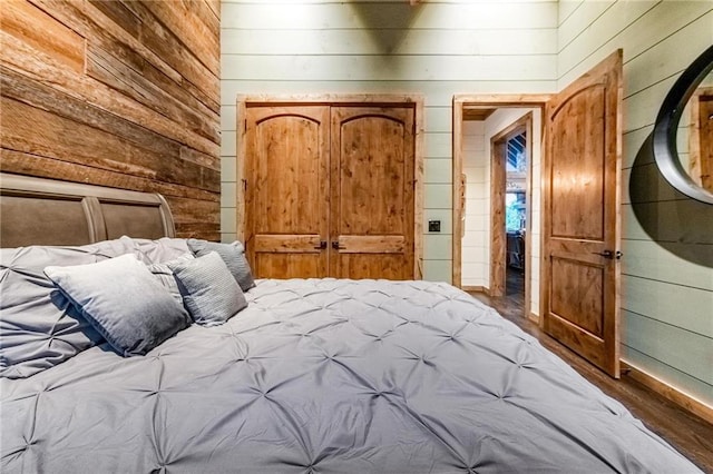 unfurnished bedroom featuring wood-type flooring and wood walls