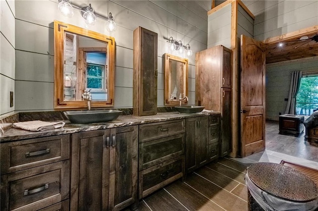 bathroom featuring tile patterned flooring, vanity, and tile walls