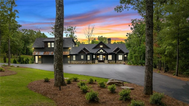 view of front of property with a lawn and a garage