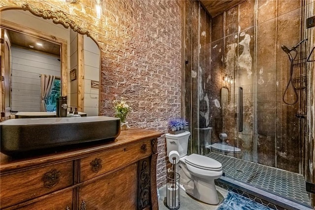 bathroom featuring a shower with door, vanity, and toilet