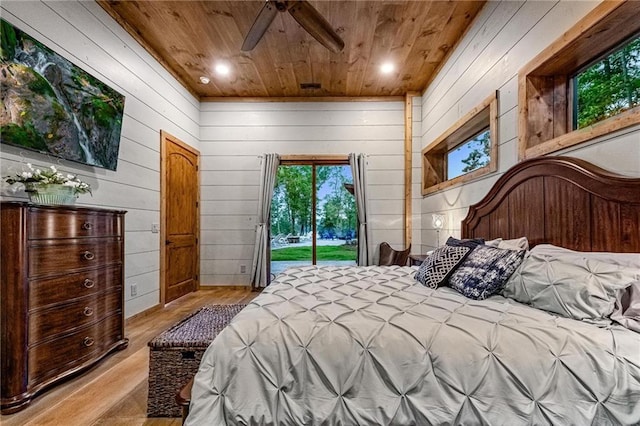 bedroom with access to outside, ceiling fan, wooden walls, light hardwood / wood-style flooring, and wooden ceiling