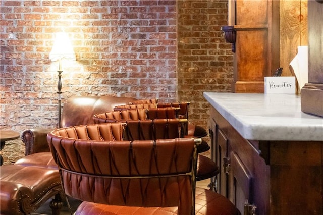 bar with light tile patterned flooring and brick wall