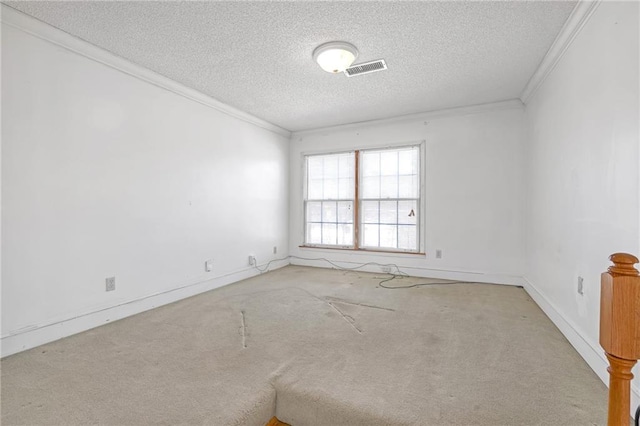 carpeted spare room with visible vents, crown molding, and a textured ceiling