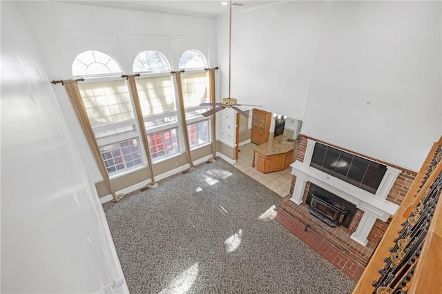 living area with a ceiling fan and baseboards