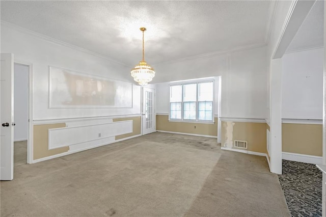 unfurnished dining area with carpet flooring, crown molding, a textured ceiling, and a notable chandelier