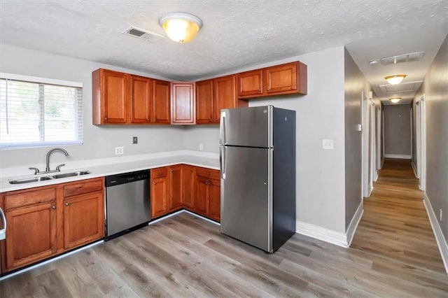 2222 Mcafee Rd, Decatur, GA 30032 - kitchen with sink, light wood-type flooring, a textured ceiling, and appliances with stainless steel finishes