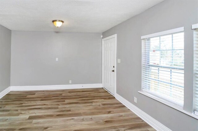 2222 Mcafee Rd, Decatur, GA 30032 - unfurnished room with hardwood / wood-style flooring and a textured ceiling