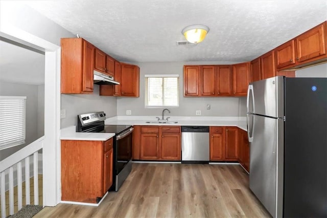 2222 Mcafee Rd, Decatur, GA 30032 - kitchen with sink, stainless steel appliances, a textured ceiling, and light wood-type flooring