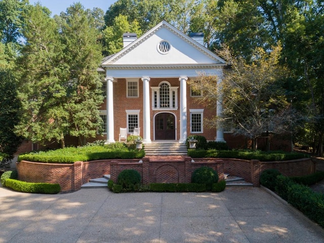 greek revival inspired property featuring french doors