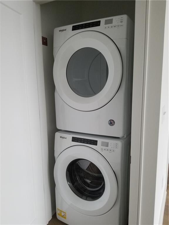 laundry area with stacked washer and clothes dryer