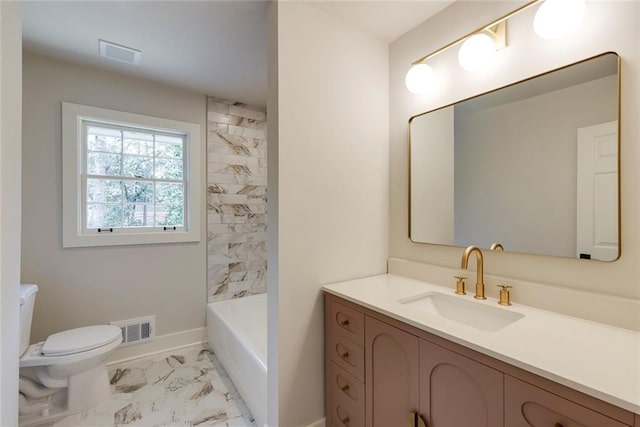 full bathroom featuring vanity, tiled shower / bath combo, and toilet