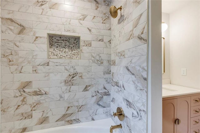 bathroom with tiled shower / bath and vanity