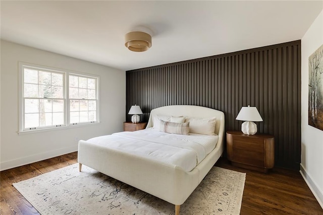 bedroom with dark wood-type flooring